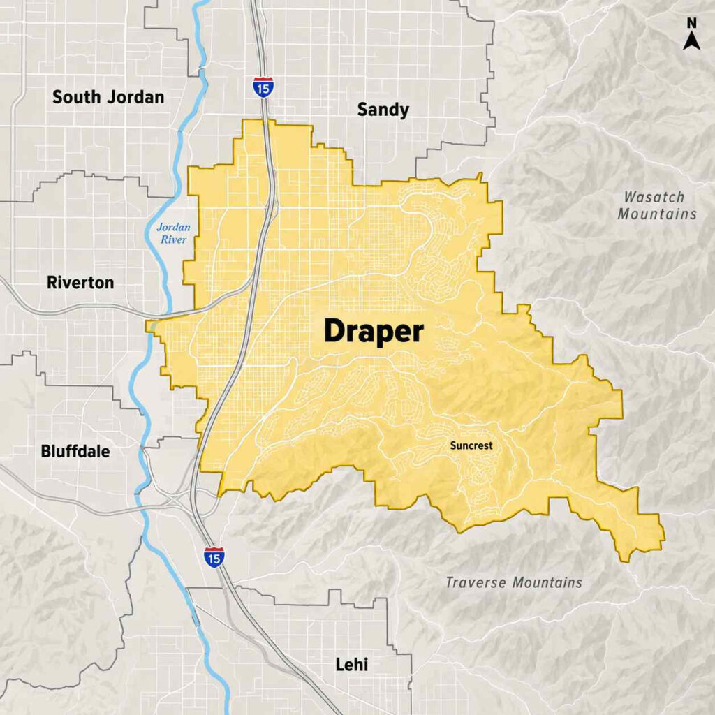 Map of draper, utah, highlighted in yellow between the jordan river and wasatch mountains, showing suncrest and nearby sandy, riverton, bluffdale, and lehi.